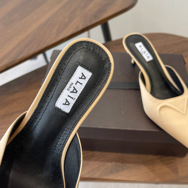 ALAIA 26S HEELED MULES 50 MM IN WARM BEIGE FABRIC