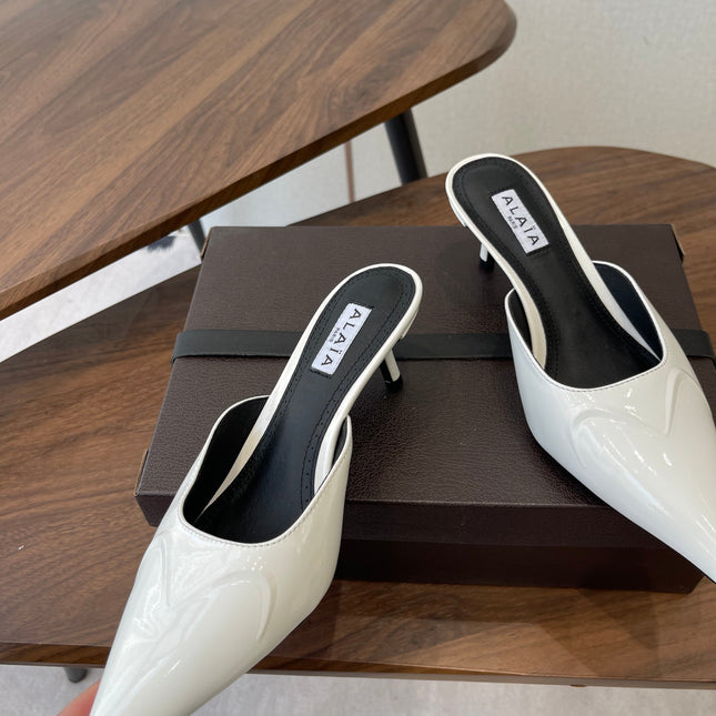 ALAIA 26S HEELED MULES 50 MM IN WHITE GLOSSY CALFSKIN