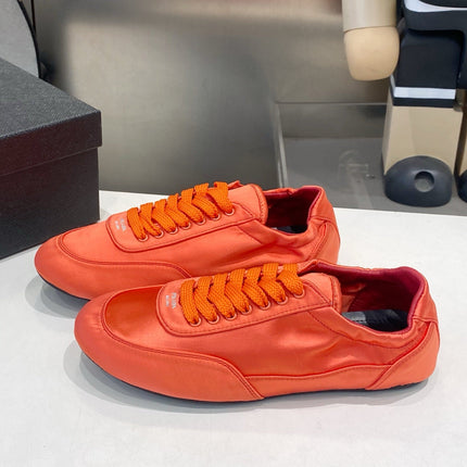 PRADA 26S SNEAKERS IN BURNT ORANGE SATIN