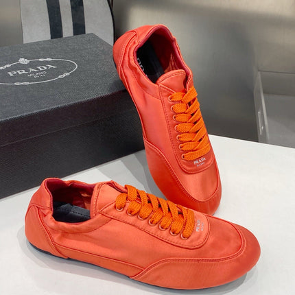 PRADA 26S SNEAKERS IN BURNT ORANGE SATIN