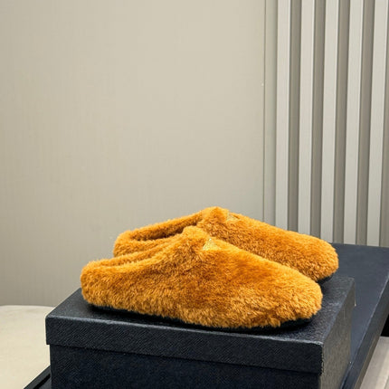 PRADA 25S CLOGS IN DARK ORANGE SHEARLING
